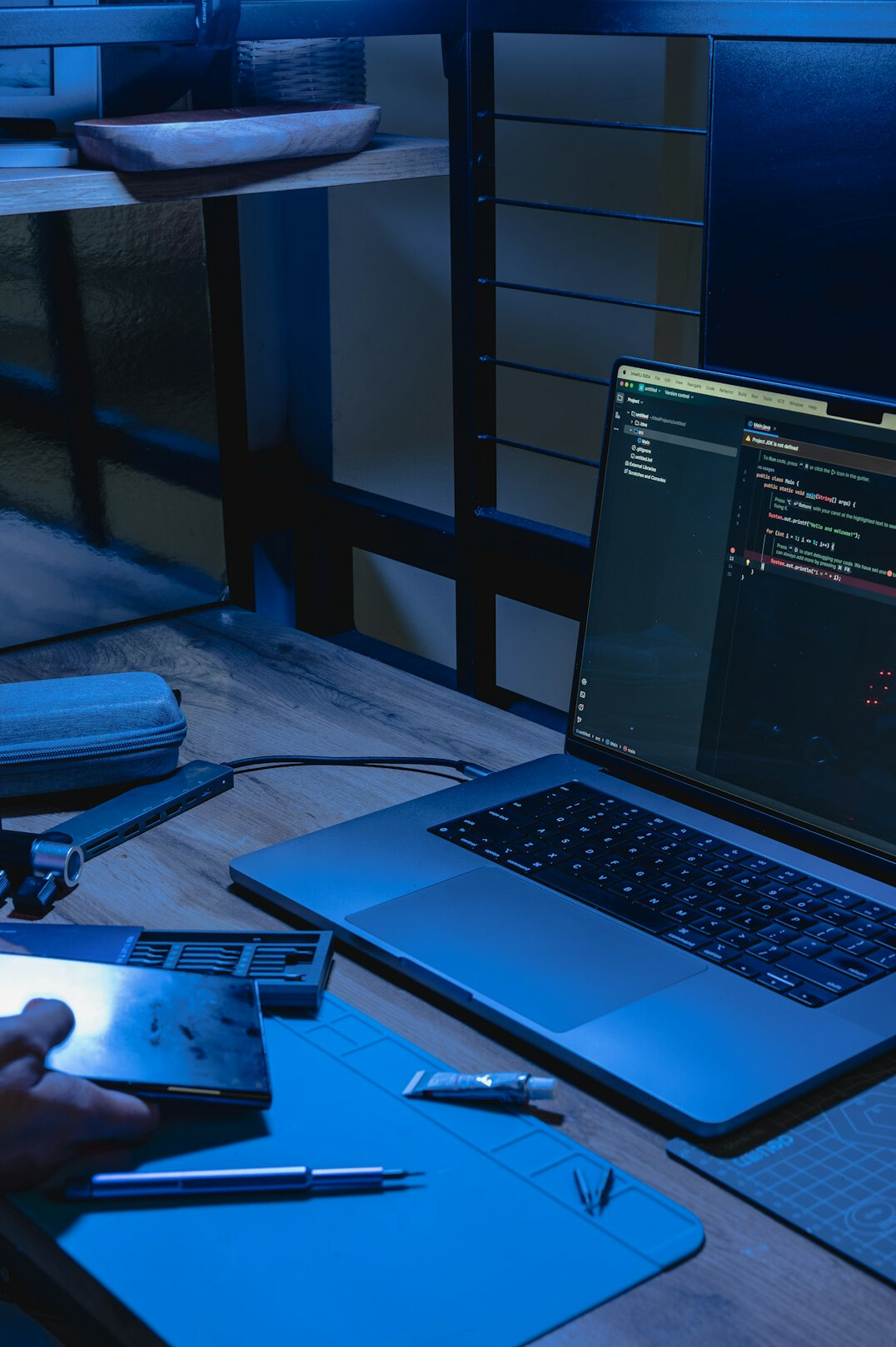 programmer coding on laptop
