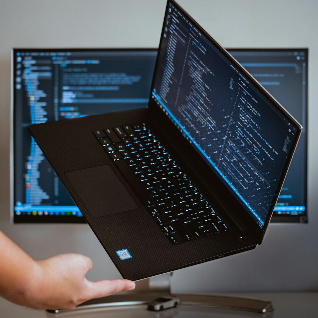 programmer coding on laptop