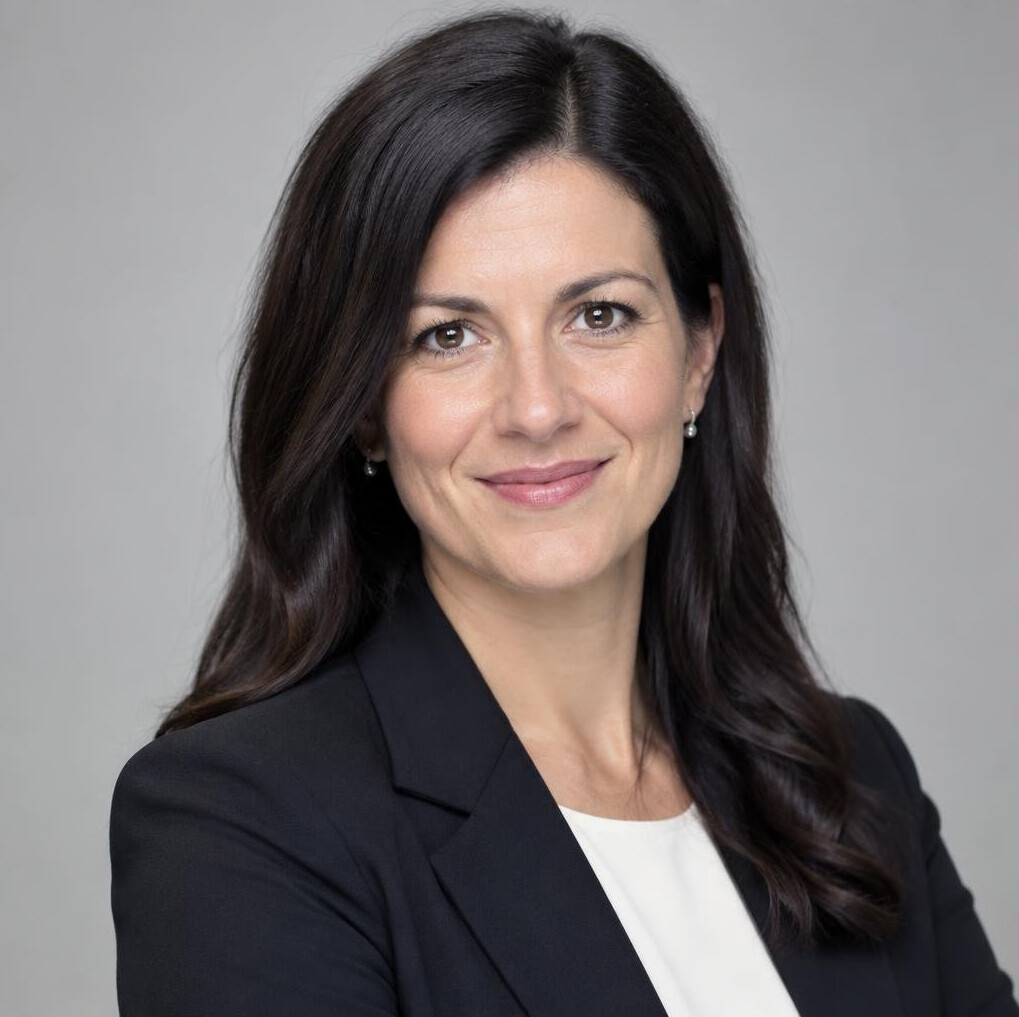 Professional woman in a blazer smiling